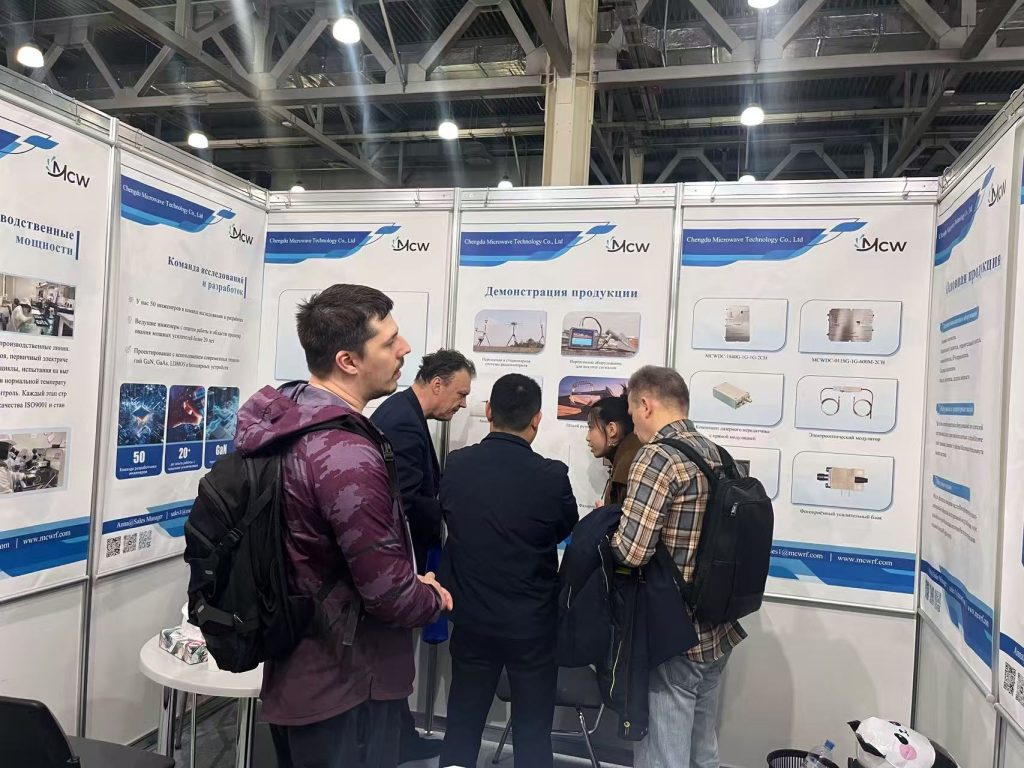 Mcw engineers discussing RF technology and quality control with exhibition visitors